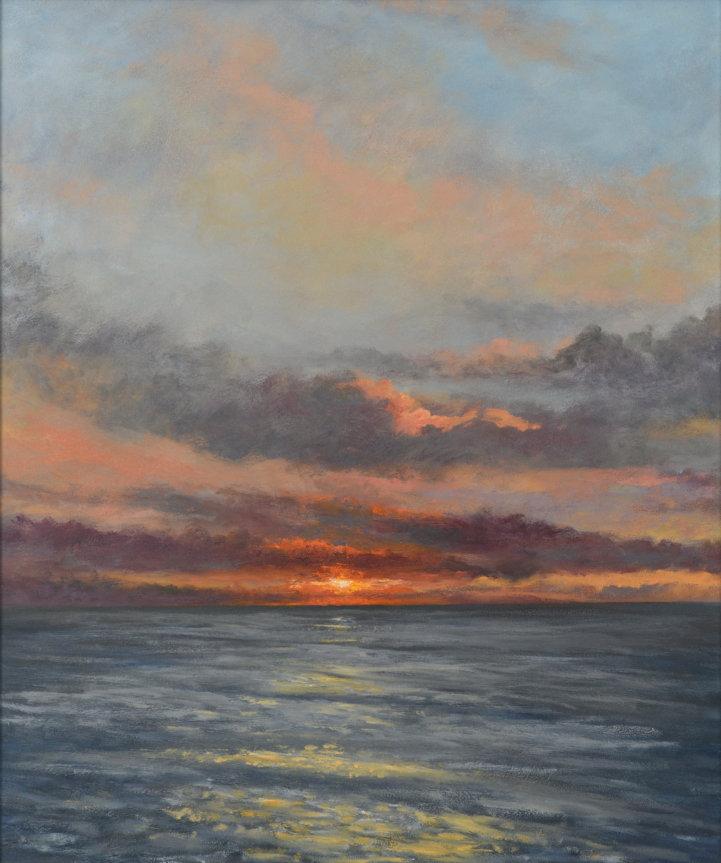 A fine art print of a low sunset over the sea with a dramatic sky in orange, pinks, purples and blues.