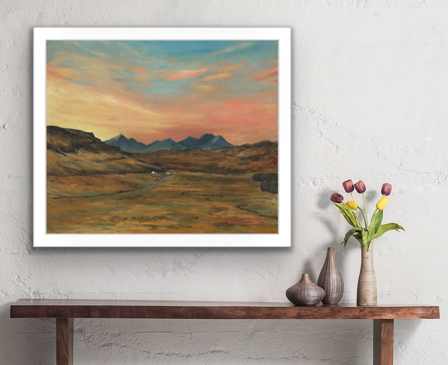Oil painting of view of Cuillin Hills at sunrise with peach and yellow clouds
