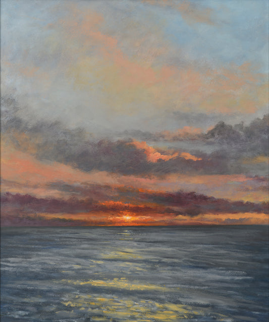 A fine art print of a low sunset over the sea with a dramatic sky in orange, pinks, purples and blues.